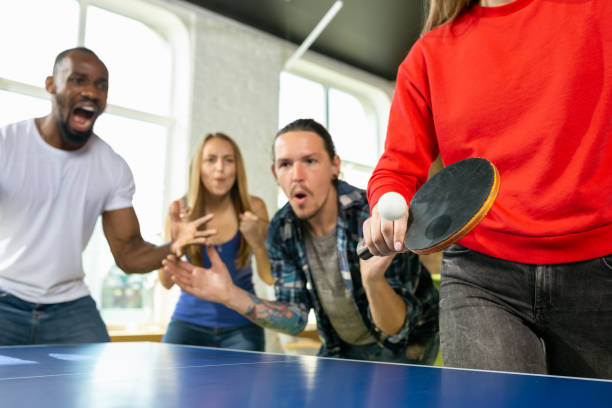 istock Young people playing table tennis in workplace, having fun 1184584296