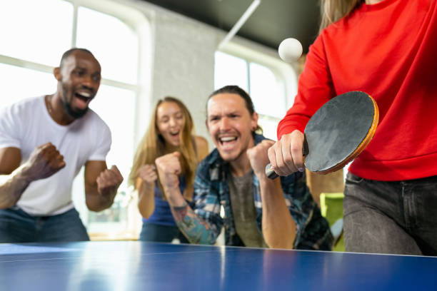istock Young people playing table tennis in workplace, having fun 1184584306