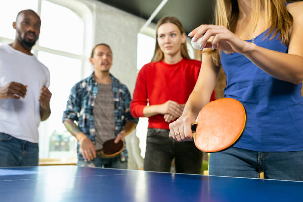 istock Young people playing table tennis in workplace, having fun 1184584323