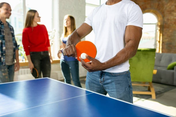istock Young people playing table tennis in workplace, having fun 1184584353