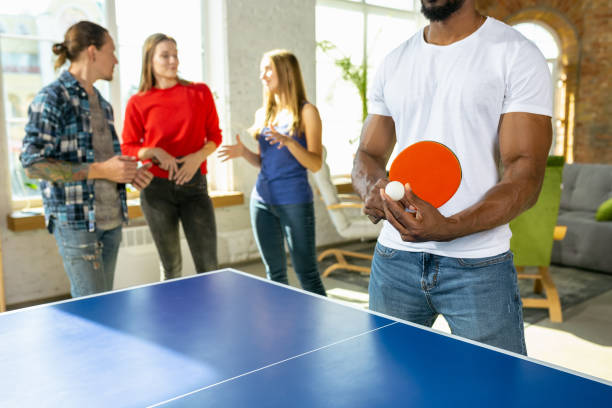 istock Young people playing table tennis in workplace, having fun 1184584363