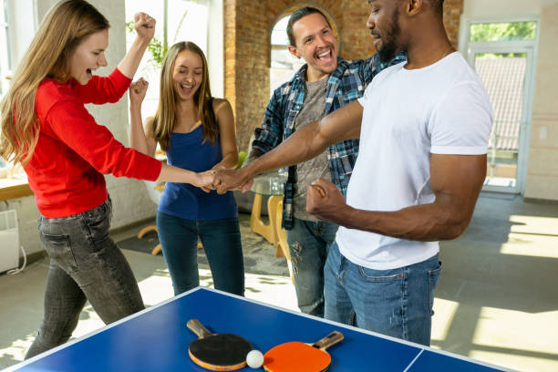 istock Young people playing table tennis in workplace, having fun 1184584874