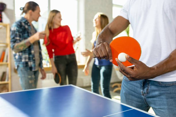 istock Young people playing table tennis in workplace, having fun 1184584884