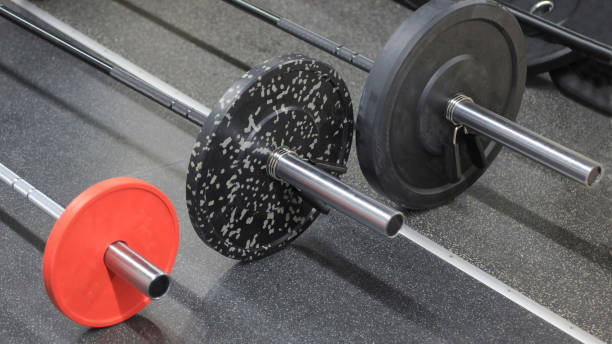 istock Exercise equipment: three sports bars on the floor 1184588686