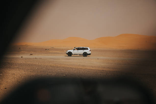 istock All terrain car crossing the desert, viewed from another car window. 1184590291