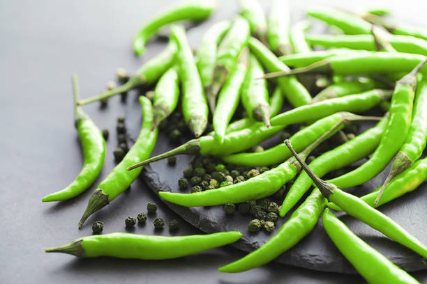 istock Hot green pepper. Chilean pepper on a black. 1184590538