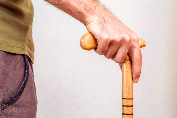 istock Male hand with walking stick holding praying beads 1184591268
