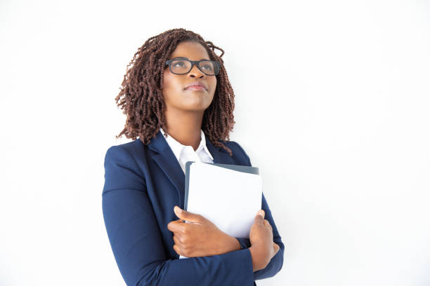 istock Pensive office assistant in glasses holding papers 1184592636