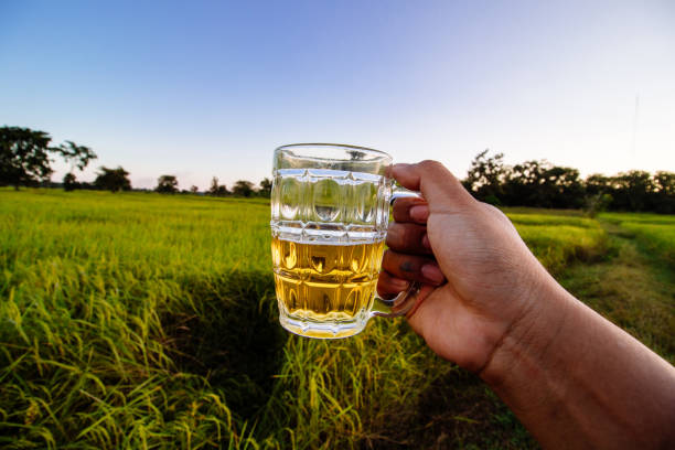 brown skin man happily drink beer