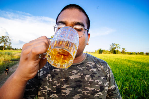 istock brown skin man happily drink beer 1184594204