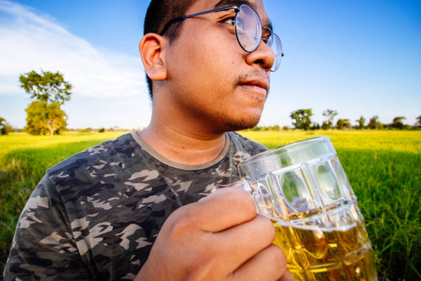 istock brown skin man happily drink beer 1184594225