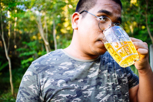 istock brown skin man happily drink beer 1184594778