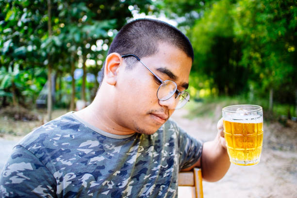 istock brown skin man happily drink beer 1184594837