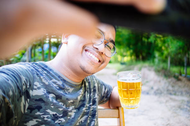 brown skin man happily drink beer