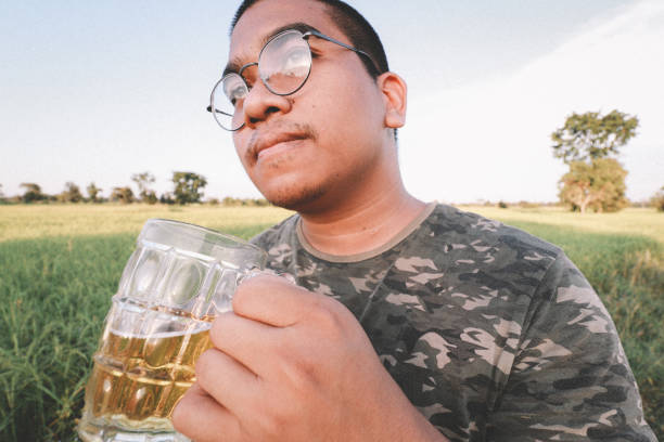 brown skin man happily drink beer