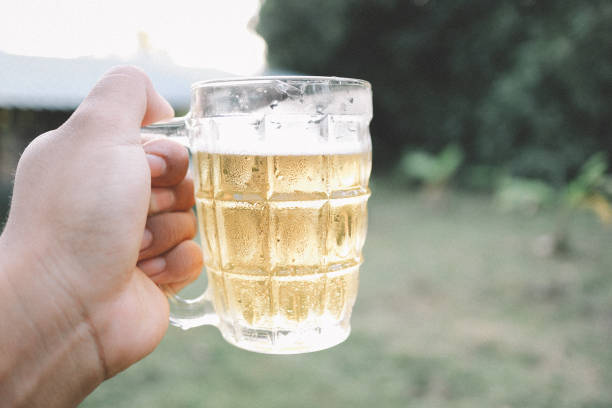 brown skin man happily drink beer