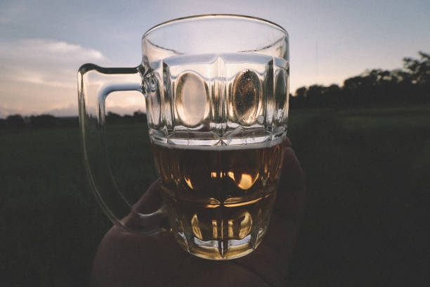 brown skin man happily drink beer