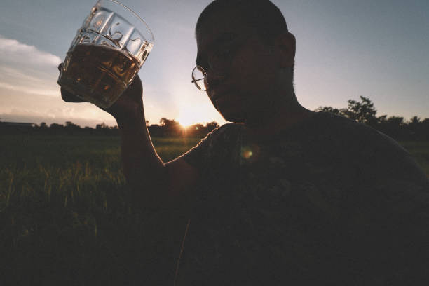 istock brown skin man happily drink beer 1184595661
