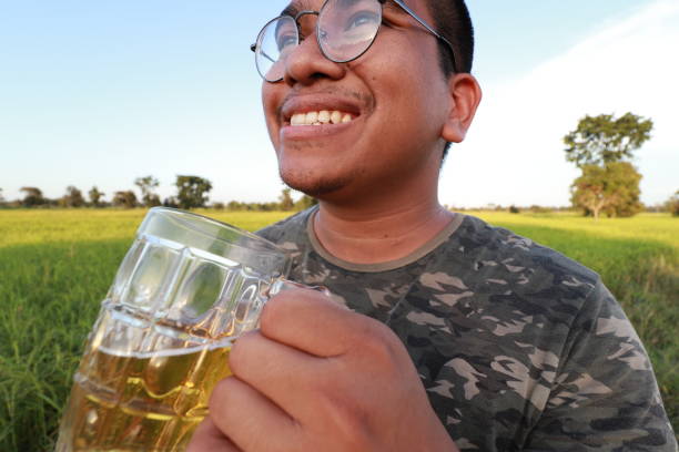 istock brown skin man happily drink beer 1184595689