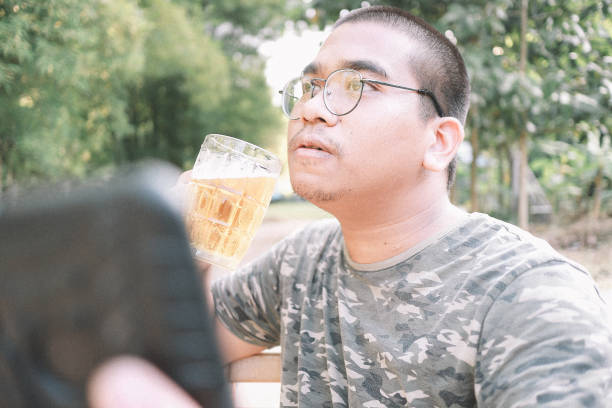 istock brown skin man happily drink beer 1184595722