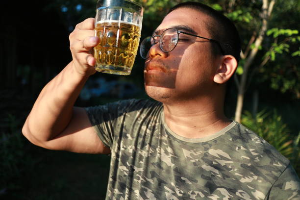 brown skin man happily drink beer