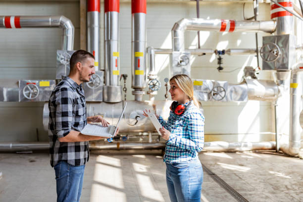 istock Teamwork in the boiler room. Young Technicians are Inspecting Heating System in Boiler Room 1184597087