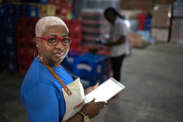 istock Portrait of mature employee using digital tablet at warehouse 1184597561