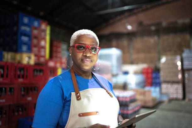istock Portrait of serious employee using digital tablet at warehouse 1184597719