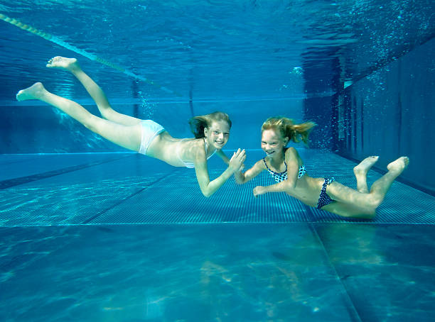 istock Girls dive in the pool together happily 118459849