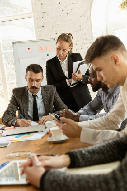 istock Group of young business professionals having a meeting, creative office 1184598509