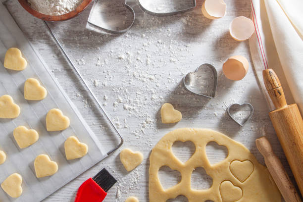 istock Making of Heart Shaped Cookies on White Kitchen Table 1184598895