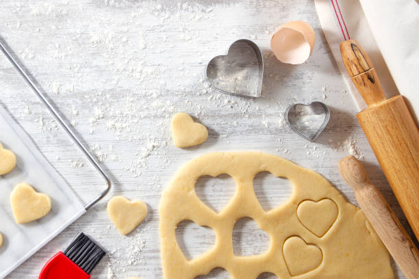 istock Making of Heart Shaped Cookies on White Kitchen Table 1184599043