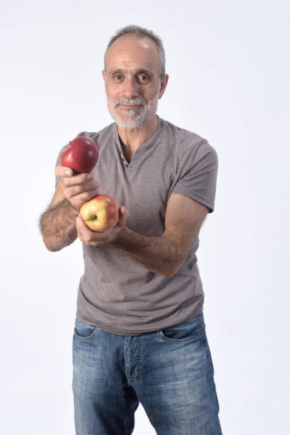 istock man with fruits on white background 1184600648