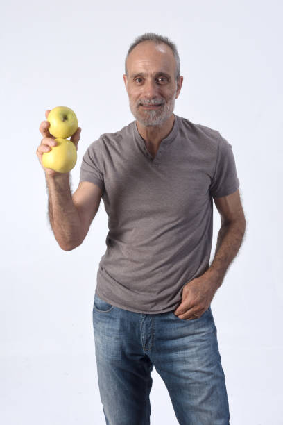 istock man with fruits on white background 1184600721
