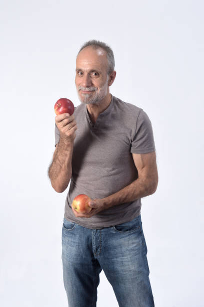 istock man with fruits on white background 1184600859