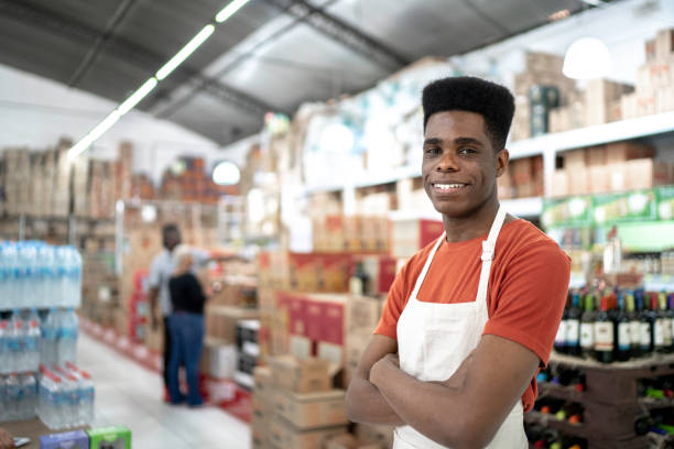 African smiling young employee portrait at wholesale African smiling young employee portrait at wholesale convenience store stock pictures, royalty-free photos & images