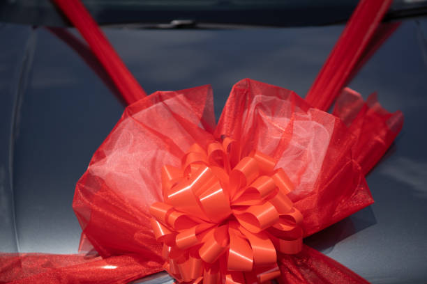 istock Red ribbon decoration on wedding car 1184601957