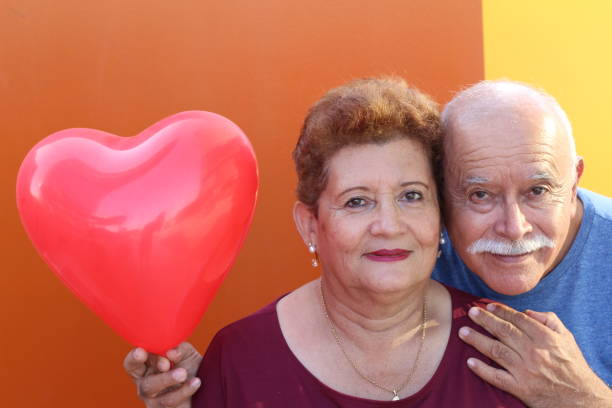 istock Senior Hispanic couple holding heart balloon 1184602045