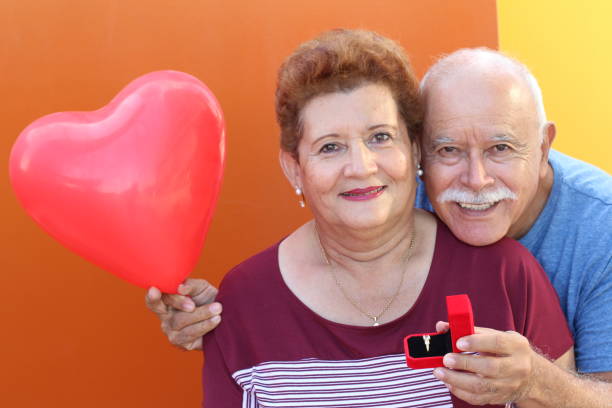 istock Hispanic husband gifting a ring to his wife 1184602136