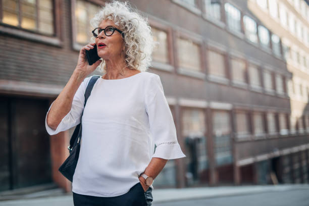 istock Woman talking on mobile on the street 1184603905
