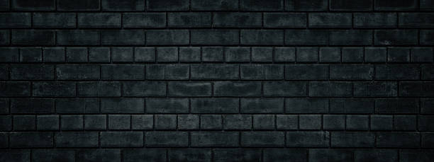 istock Black brick wall wide texture. Gloomy grunge panoramic dark background 1184605330