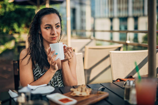 istock Beautiful lady on lunch break in restaurant alone 1184605743
