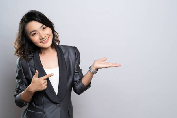 istock Happy woman present the copy space isolated over white background 1184605790