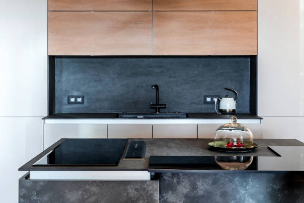 istock Minimalist wooden grey kitchen with handleless facades, impressive lamp, kitchen island and autumn decor, smart storage system. Kitchen room organization 1184605976