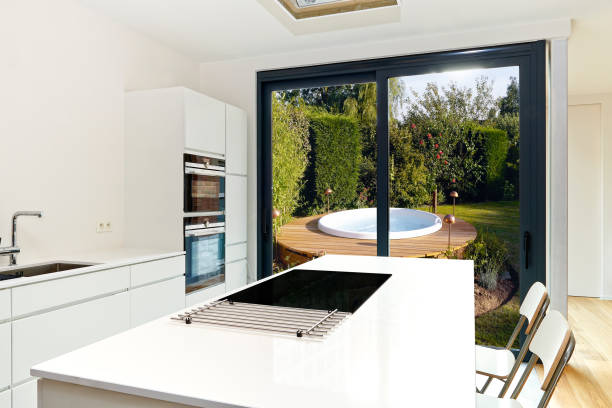 istock kitchen from loft with view on a lush garden and Hot Tub 1184606016