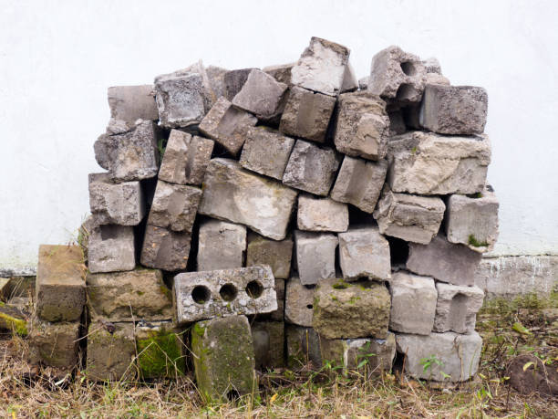 istock A pile of old gray brick on a concrete wall background 1184606757