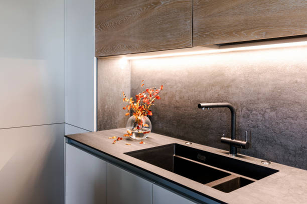istock Wooden grey kitchen room organization. Pure water and clear sink with fall decor 1184607297