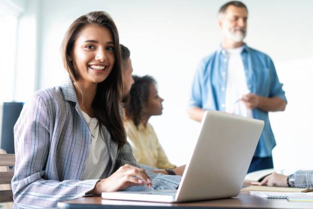 istock Beautiful business lady is looking at camera and smiling while working in office 1184610712