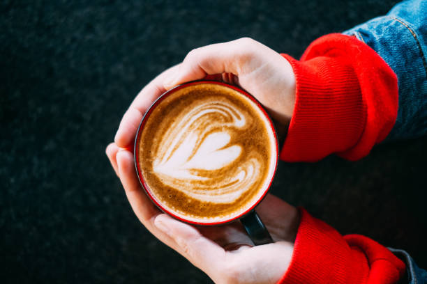 istock Top View Woman Hand Holding Latte 1184611782