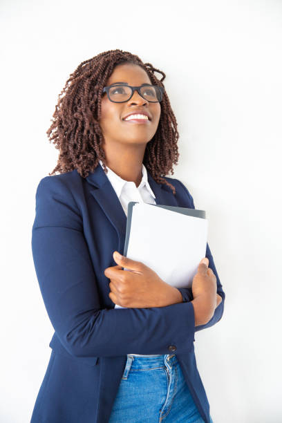 istock Joyful smiling office worker in glasses embracing papers 1184611847